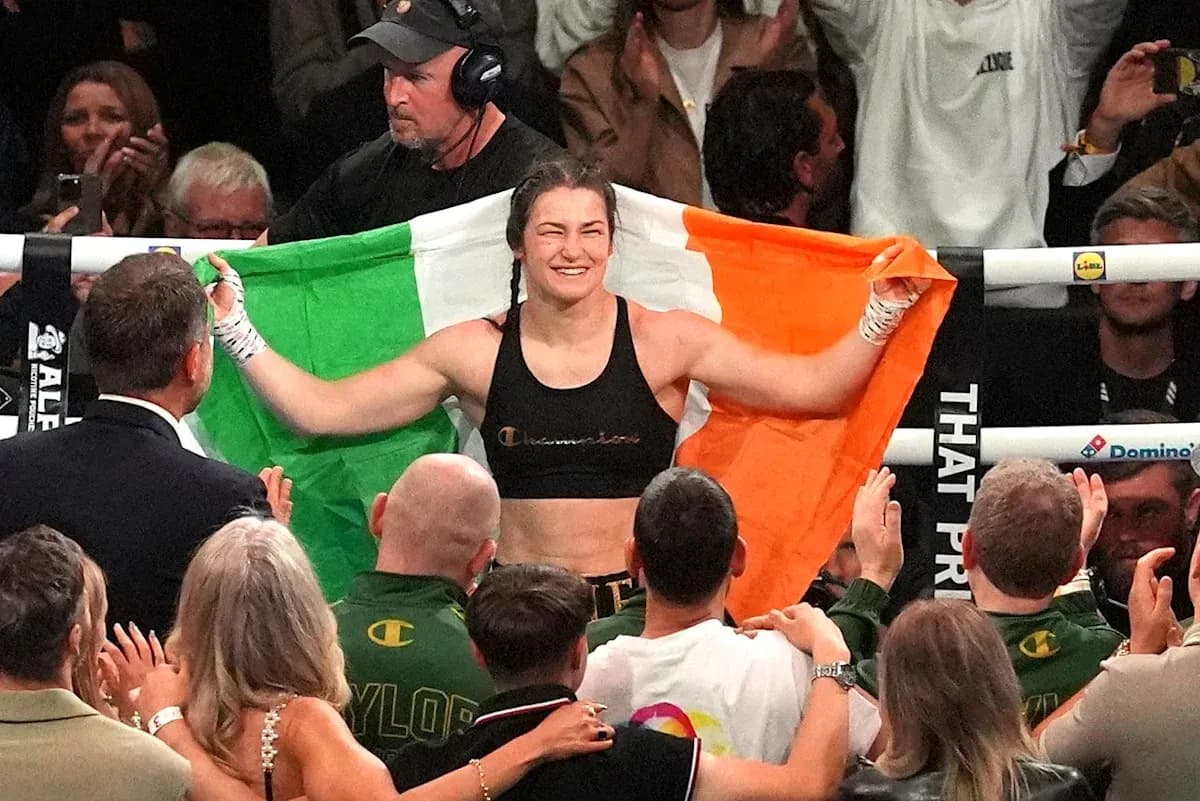 Female boxer celebrating with Irish flag after victory
