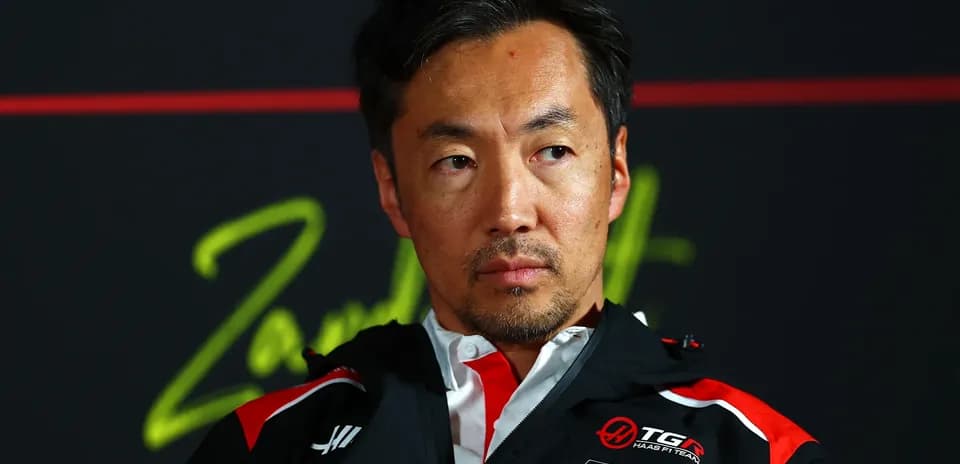 Team principal at press conference with serious expression