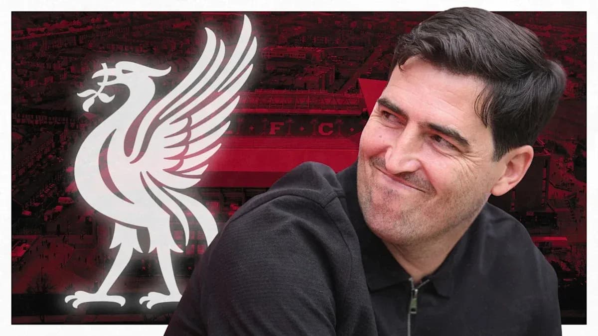 Man smiling with Liverpool logo in background