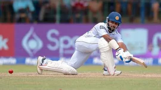Batsman playing a defensive shot in cricket match