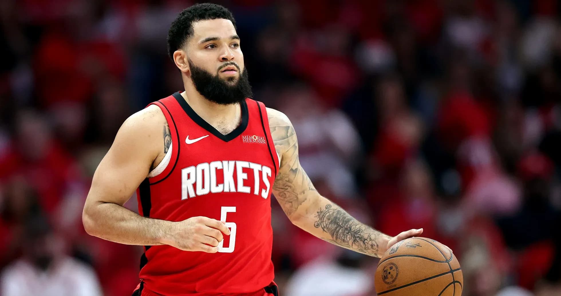 Player dribbling basketball in Houston Rockets jersey