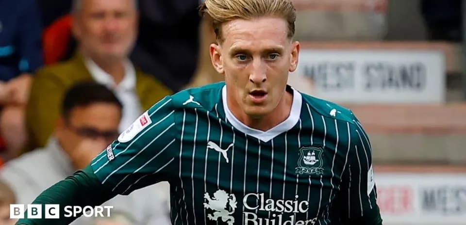 Player in green jersey running on the pitch