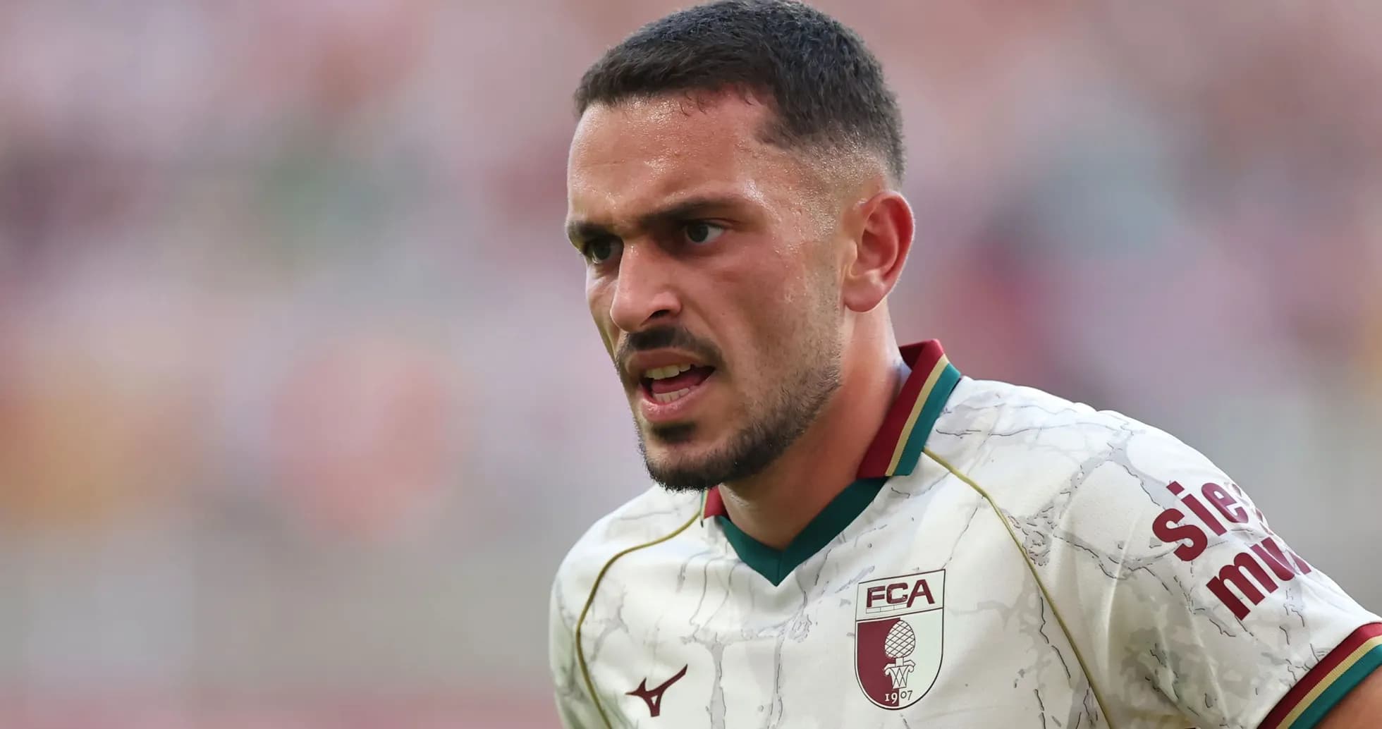 Player in action wearing FC Augsburg jersey