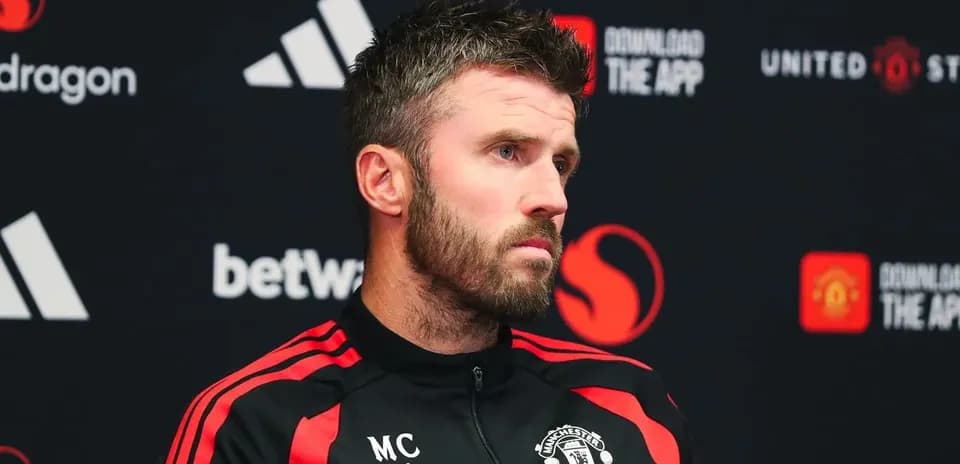 Manager speaking at press conference with Manchester United branding