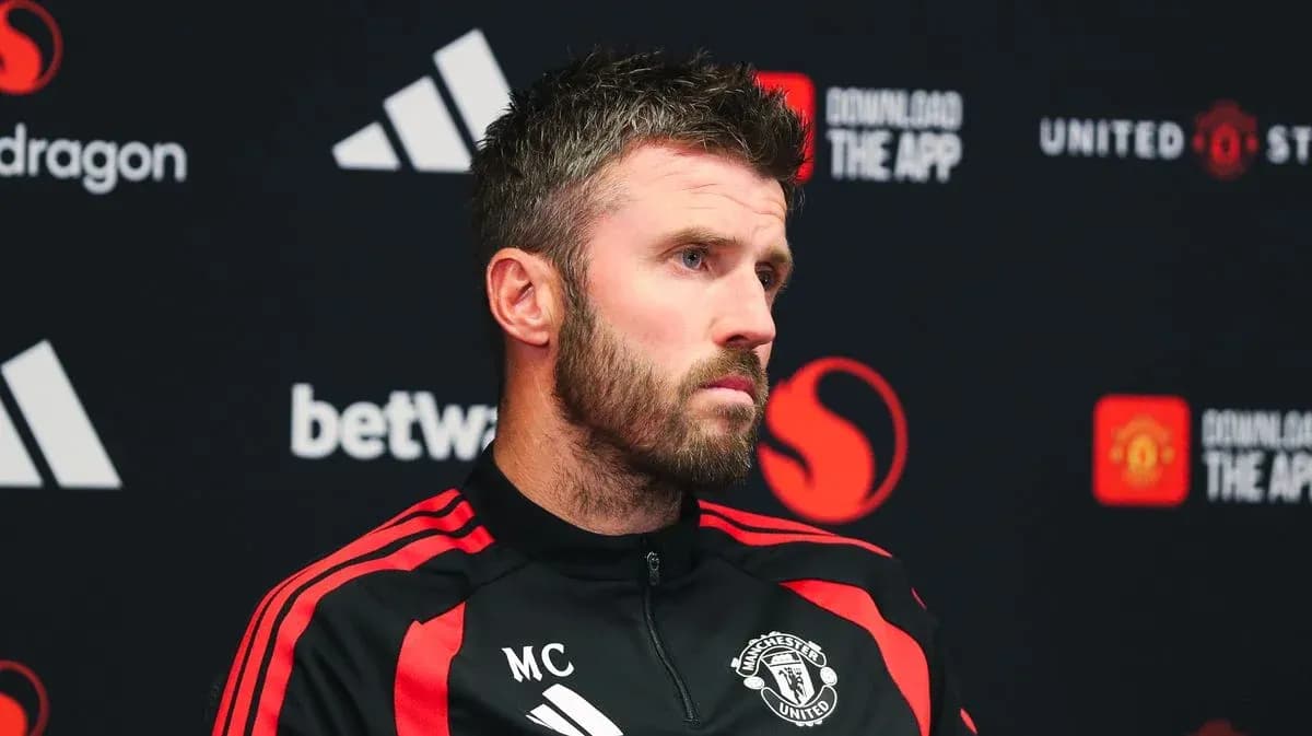 Manager speaking at press conference with Manchester United branding