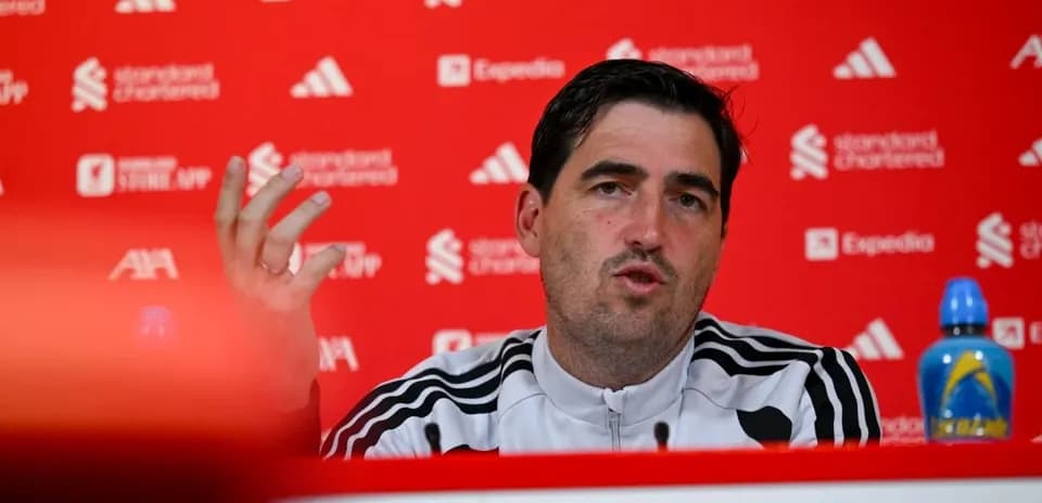 Manager speaking at press conference with sponsor backdrop