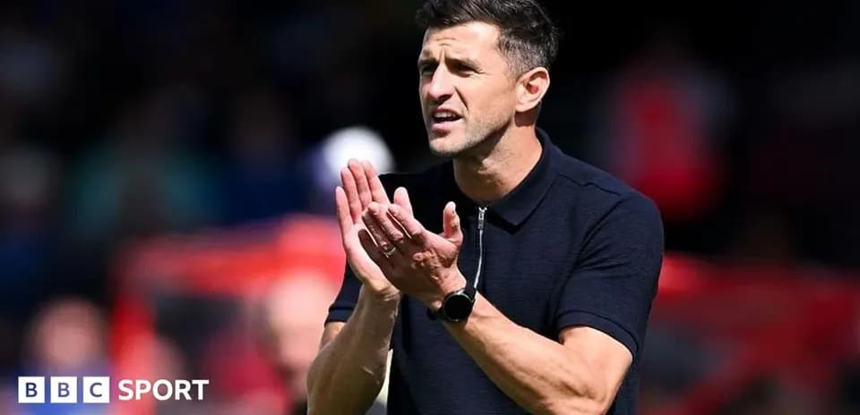 Coach gesturing during a match on the sidelines