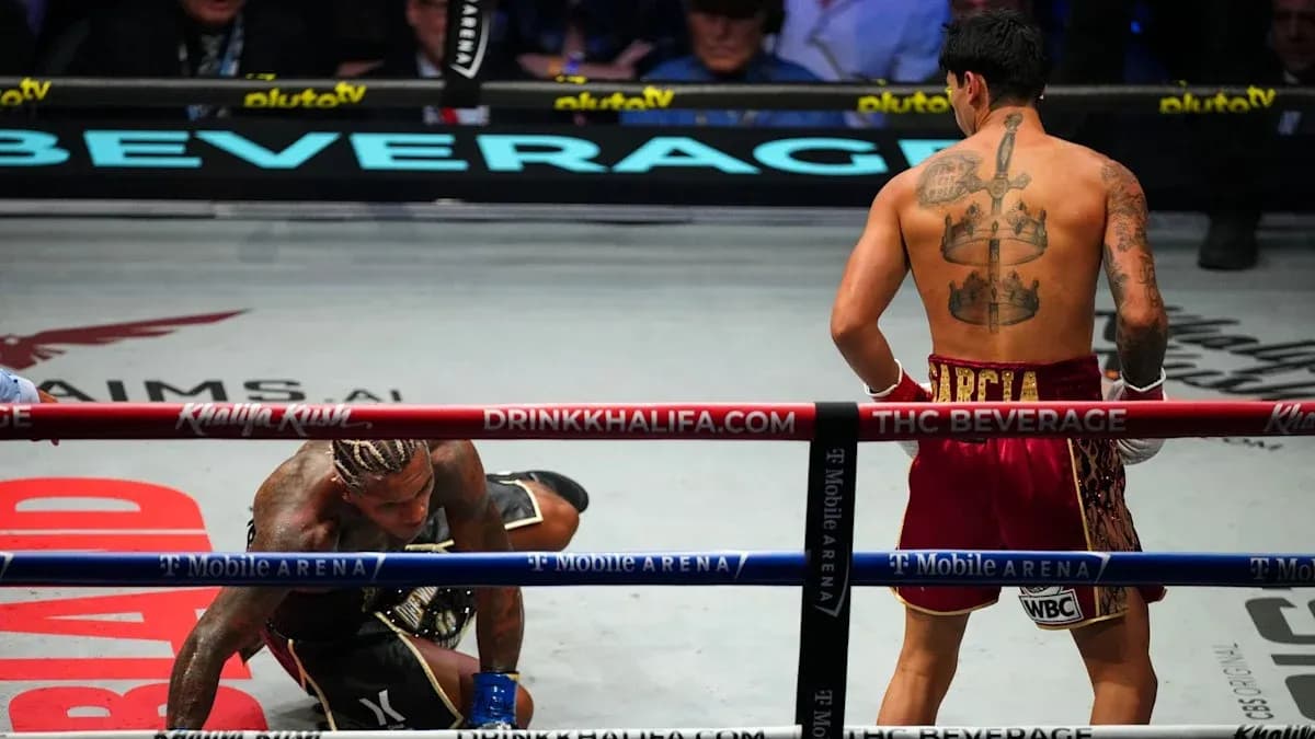 Boxer on canvas while opponent stands nearby