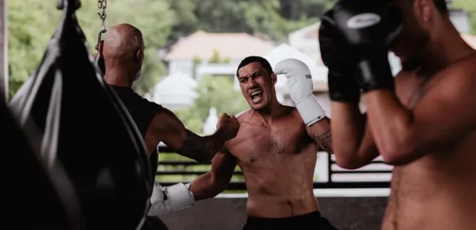 Boxers training in gym with punching bags