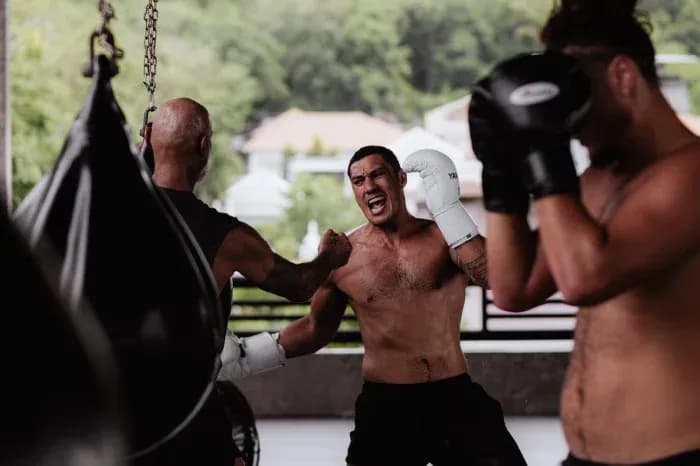 Boxers training in gym with punching bags