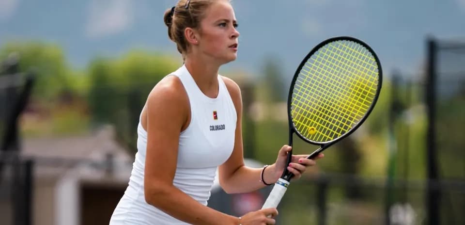 Tennis player preparing to serve on court