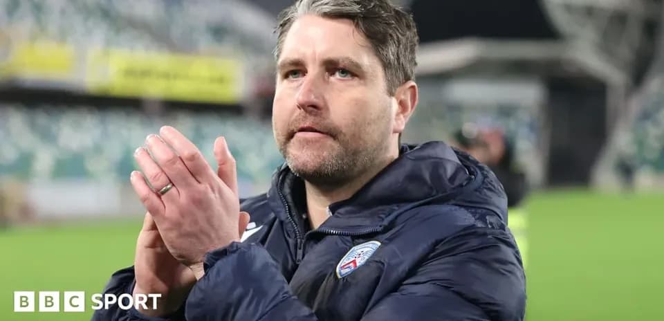Coach clapping and acknowledging fans after match