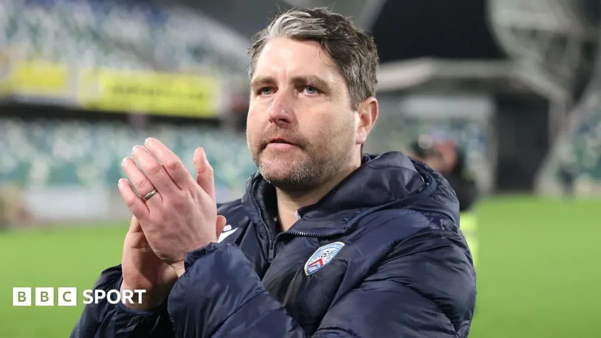 Coach clapping and acknowledging fans after match
