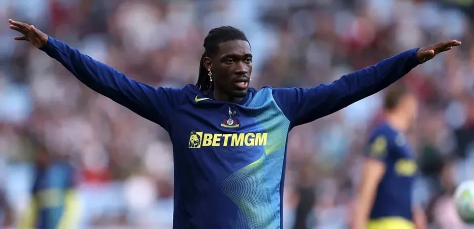 Player stretching arms during warm-up on pitch