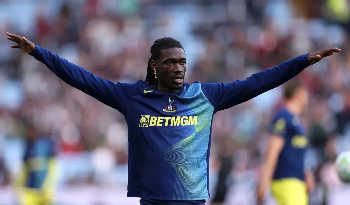 Player stretching arms during warm-up on pitch