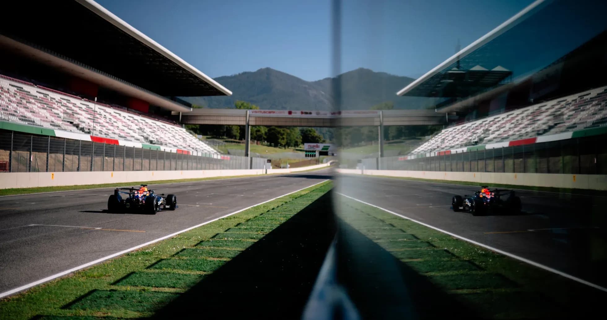 Race car on track at circuit with grandstands