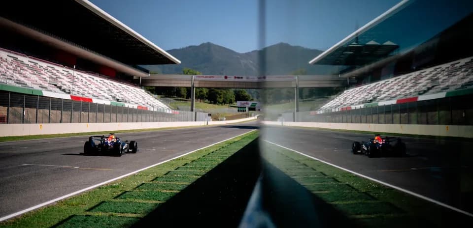 Race car on track at circuit with grandstands