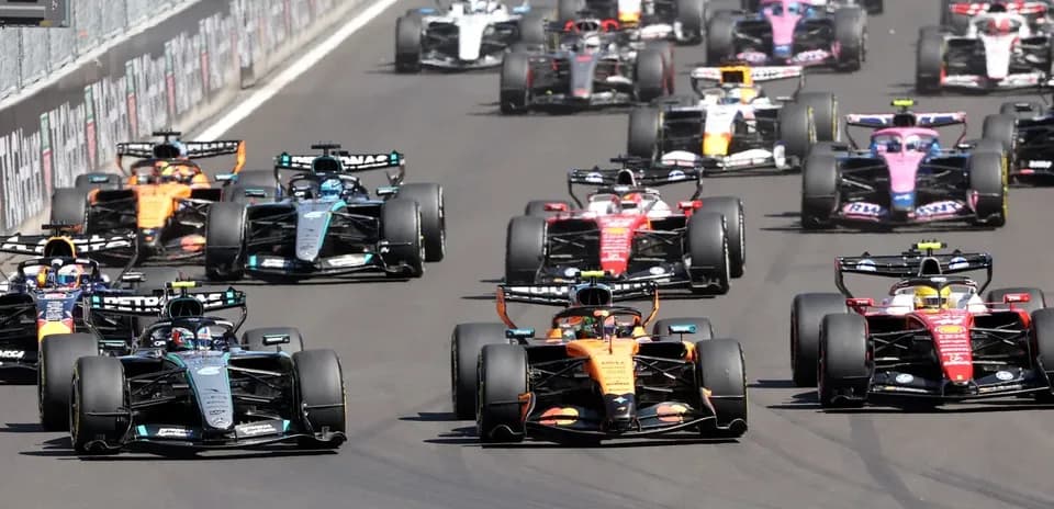 Formula 1 cars racing closely on track