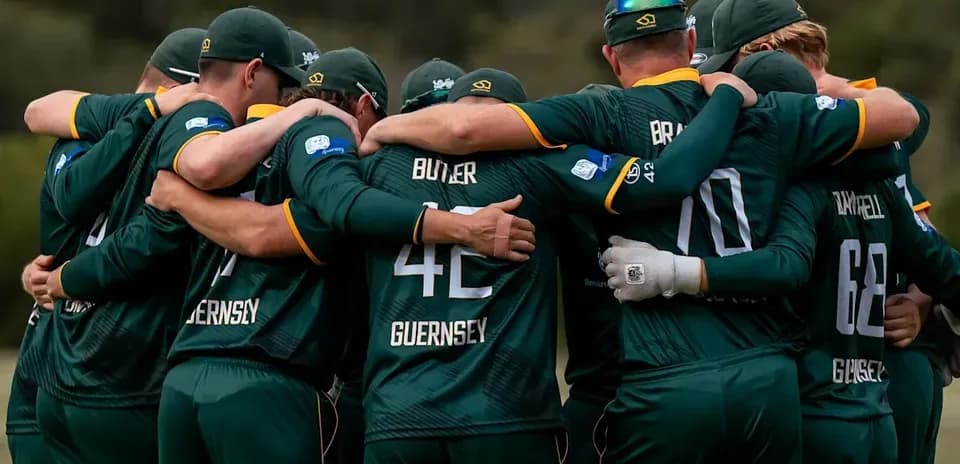 Cricket team huddling together in unity