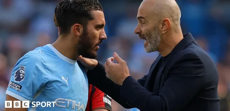 Player receiving instructions from coach on the field