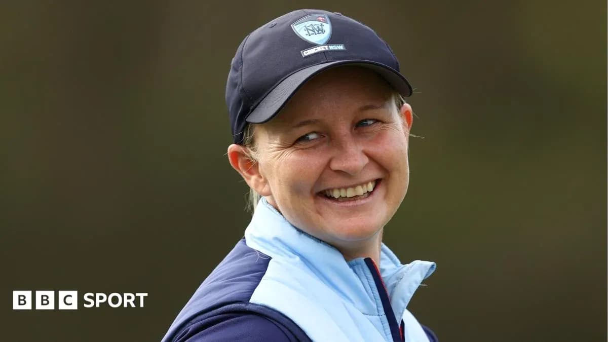 Woman smiling in cricket cap and jacket