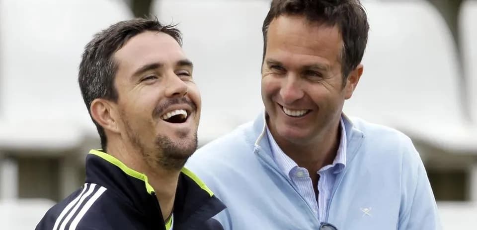 Two men laughing together at a cricket venue