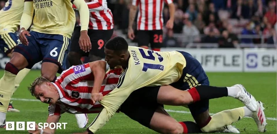 Players engaged in a tackle during a match