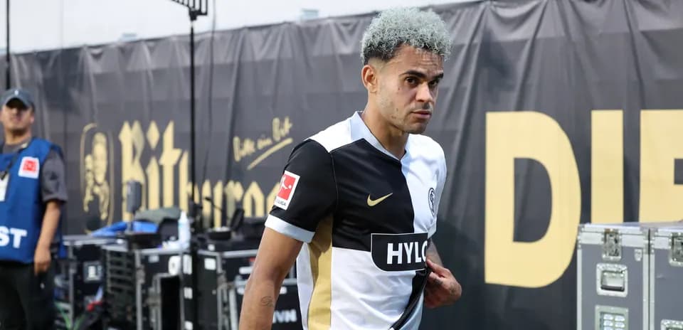 Player walking off the pitch in team uniform