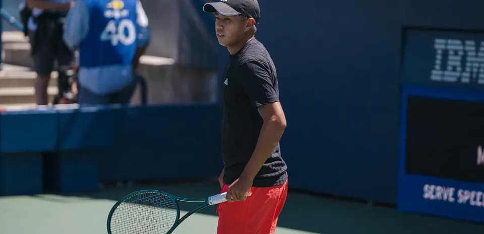 Tennis player preparing on court with racket