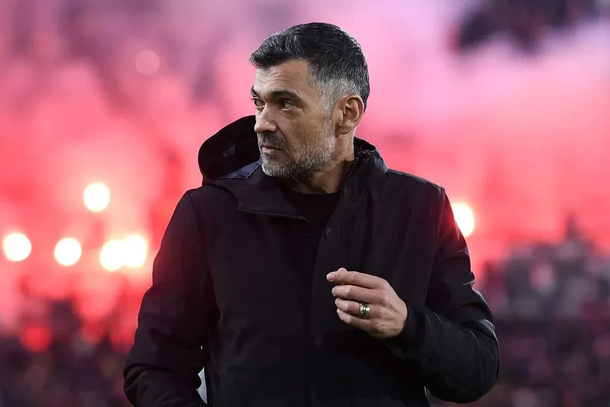 Coach observing the match with smoke in background