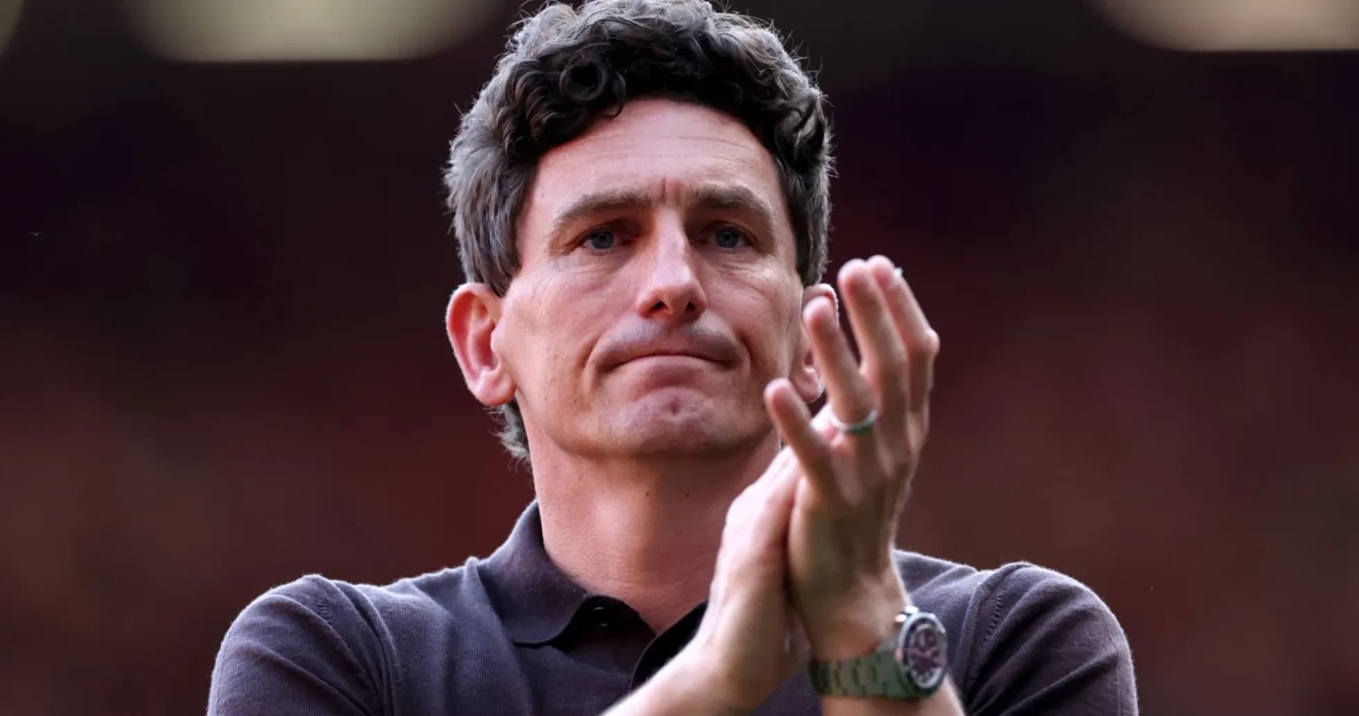 Coach applauding during match at stadium