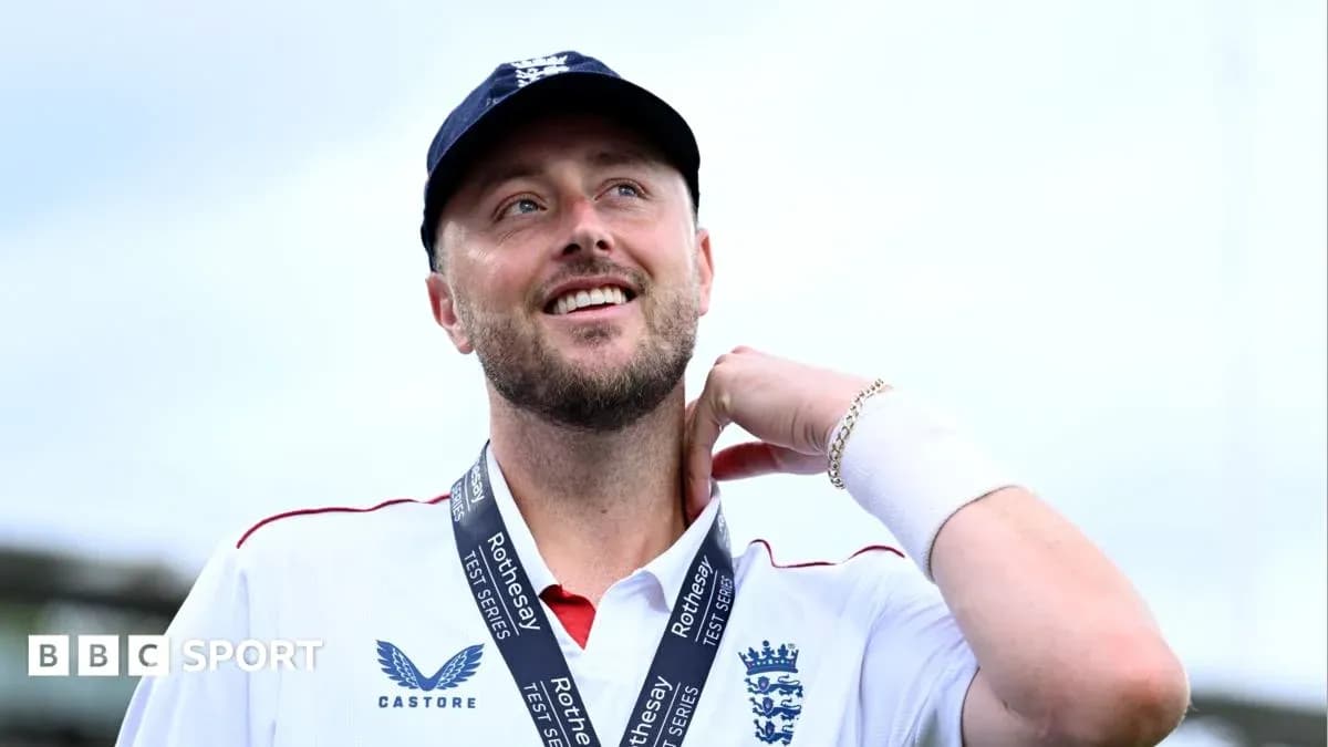 Cricketer wearing England kit with medal around neck