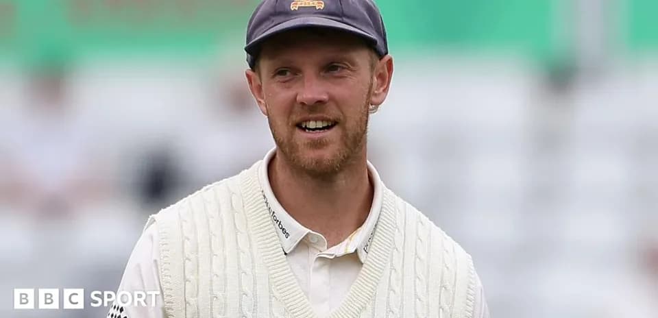 Cricketer wearing a sweater and cap on field