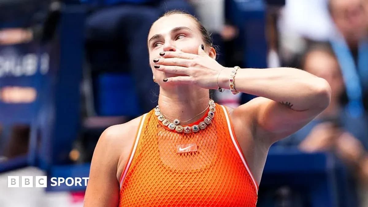 Tennis player celebrating with hand gesture on court