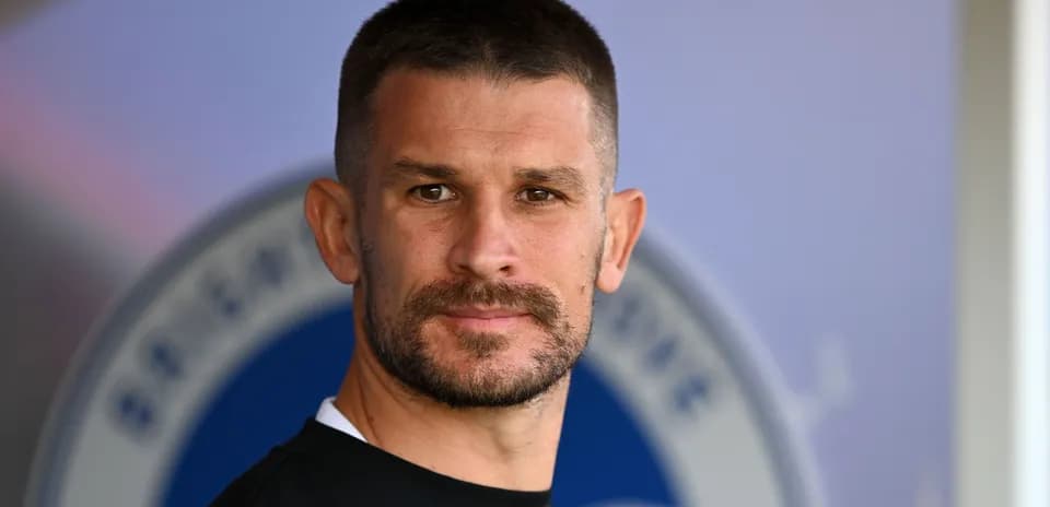 Player posing for a portrait in training gear
