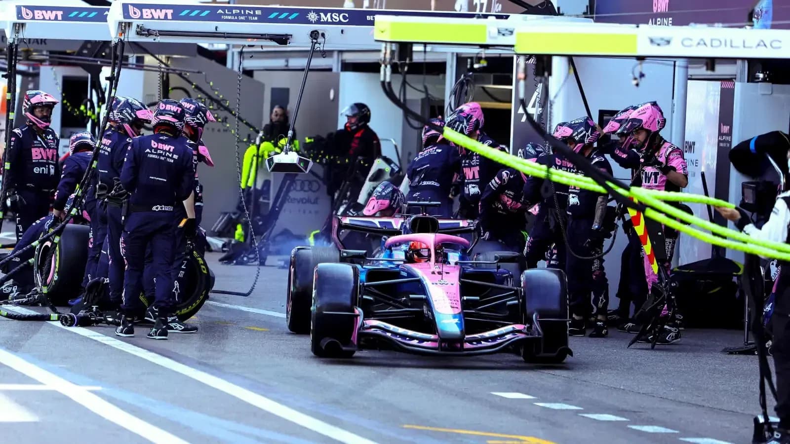 Alpine F1 car in pit stop with team members