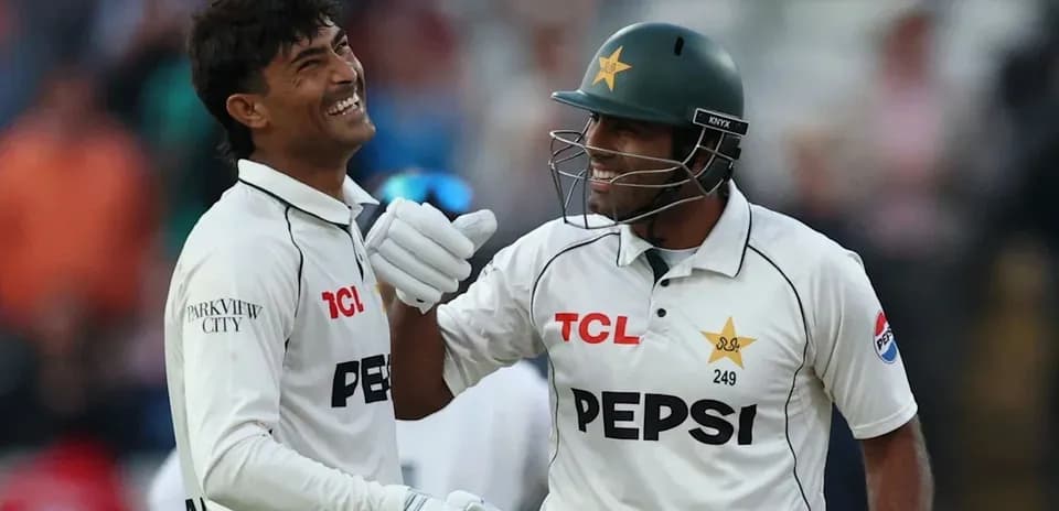 Two Pakistani cricketers celebrating on the field