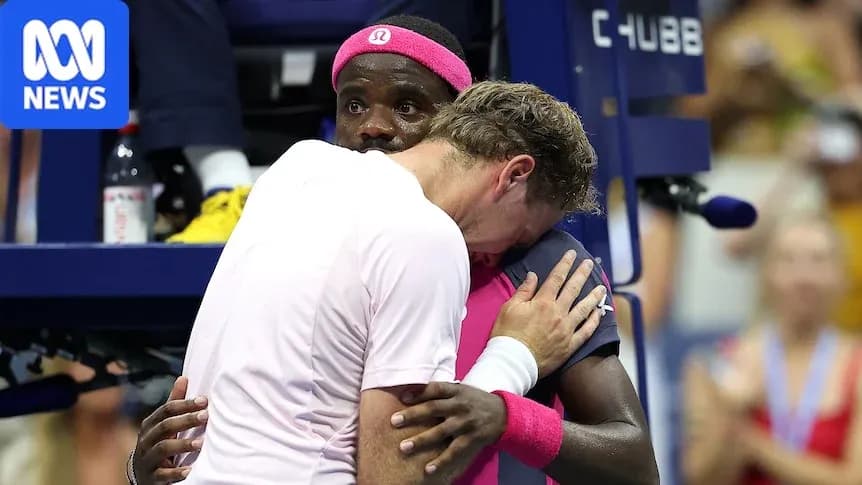 Two tennis players embracing at the net
