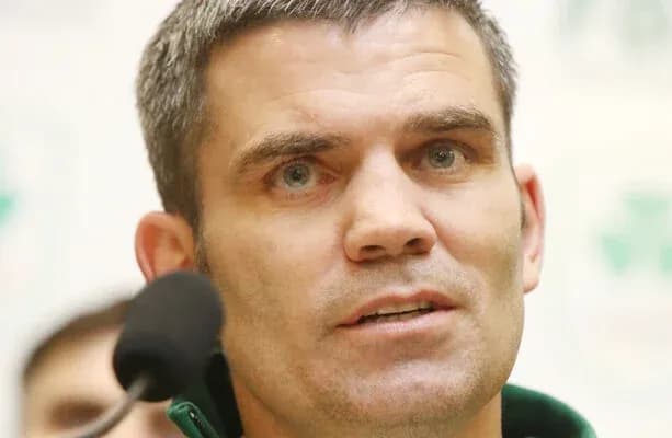Coach speaking at press conference with microphone