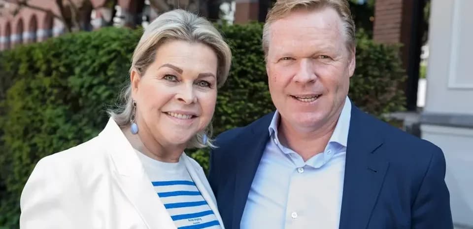 Couple posing outdoors with greenery in background