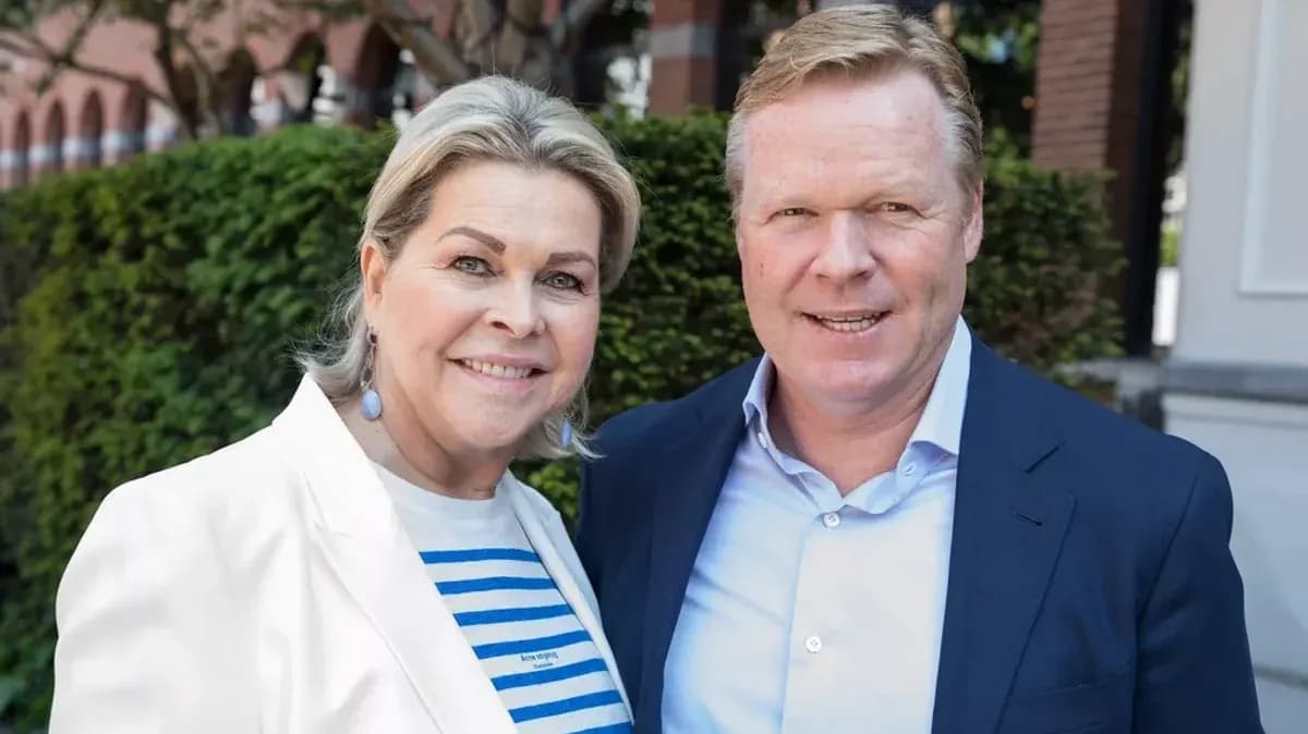 Couple posing outdoors with greenery in background