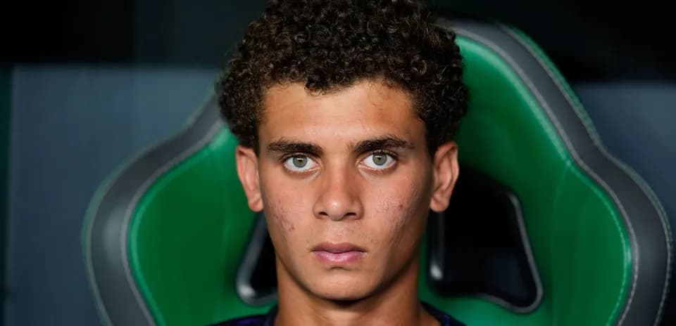 Young player sitting in sports chair, focused expression