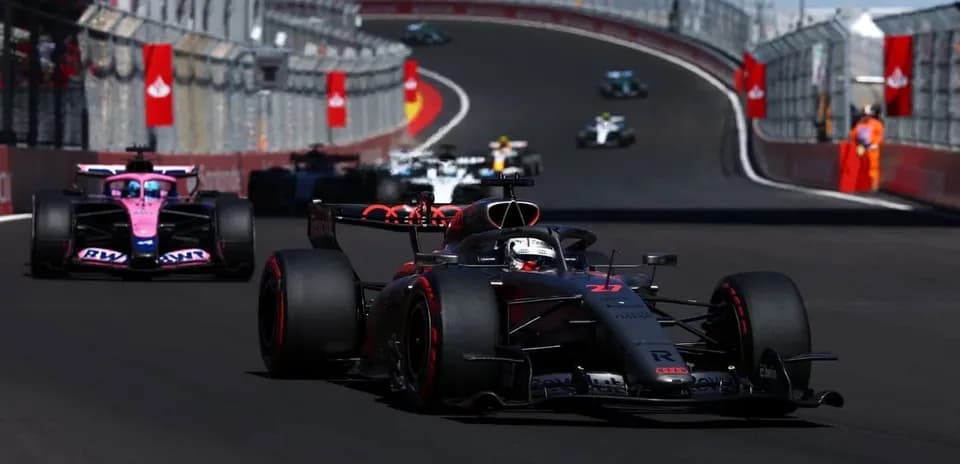 Formula 1 cars racing on a curved track