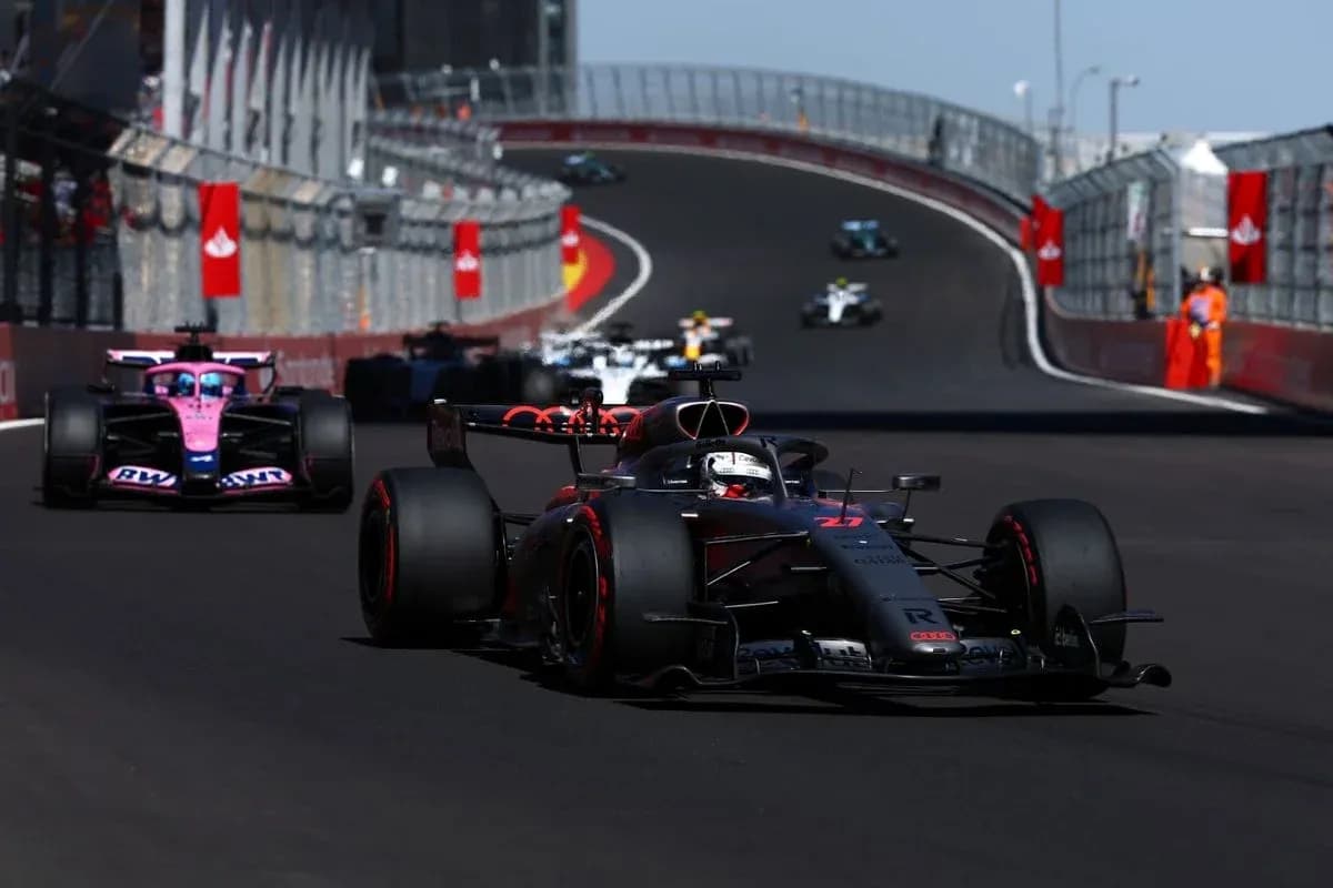 Formula 1 cars racing on a curved track