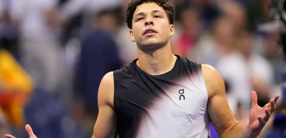Tennis player reacting during a match on court