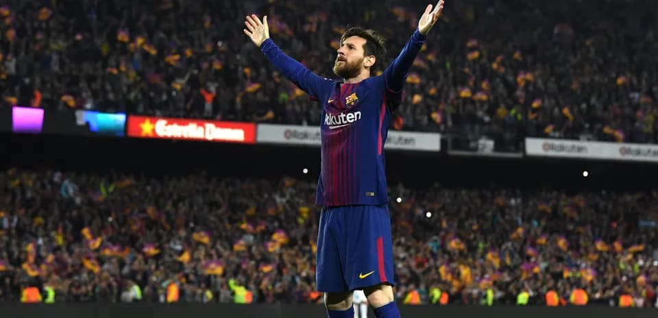 Player celebrating with arms raised in stadium