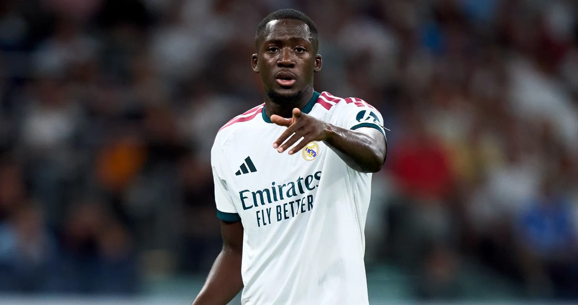 Player gesturing during match wearing Real Madrid jersey