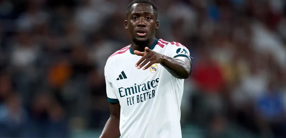 Player gesturing during match wearing Real Madrid jersey