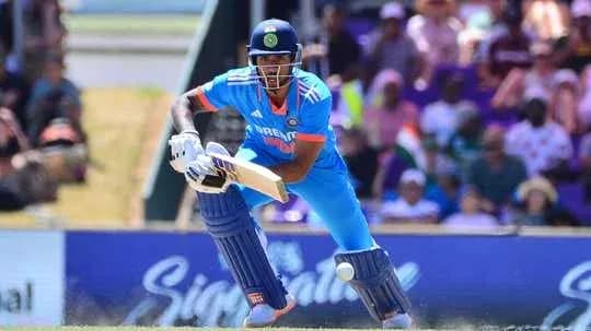 Batsman in blue uniform playing a cricket shot