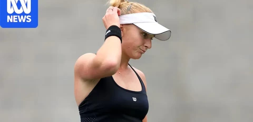 Tennis player adjusting cap during match